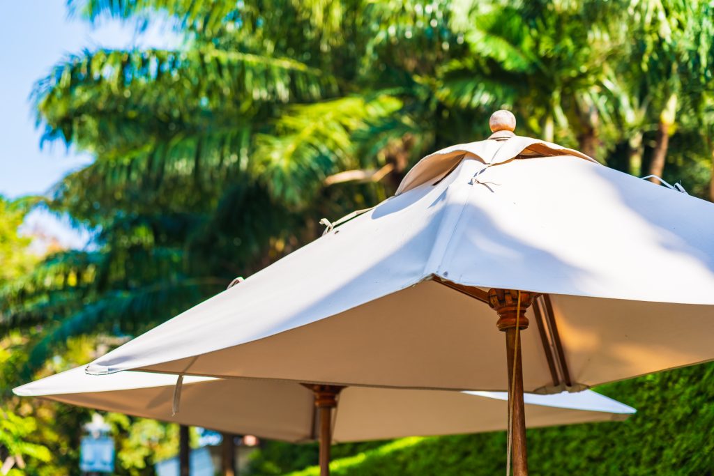 umbrella with coconut palm tree sky background